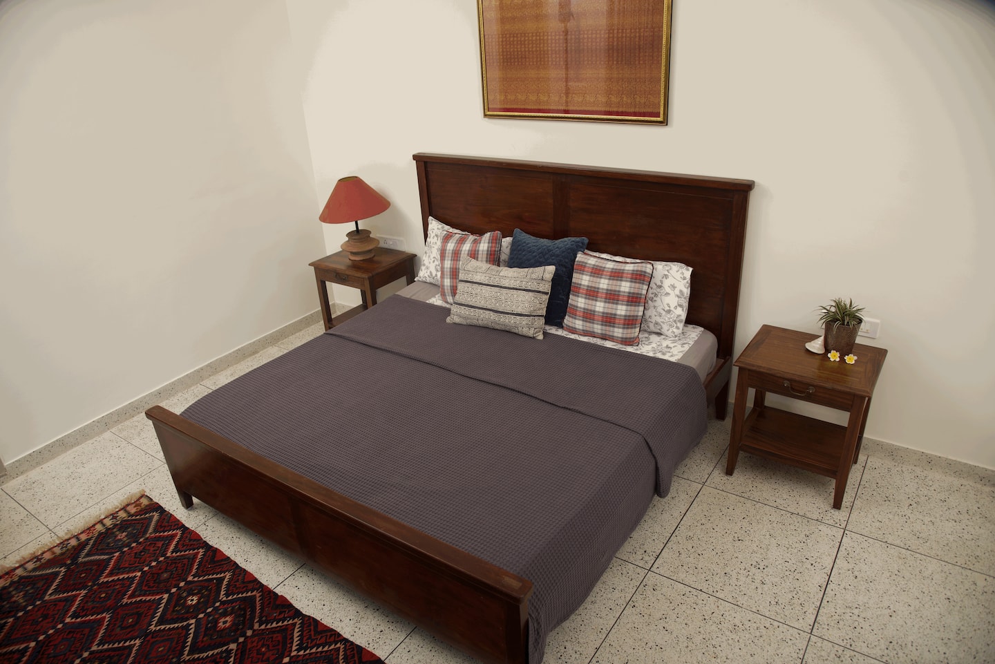 Villa 50 bedroom with a king bed and warm wooden furnishings